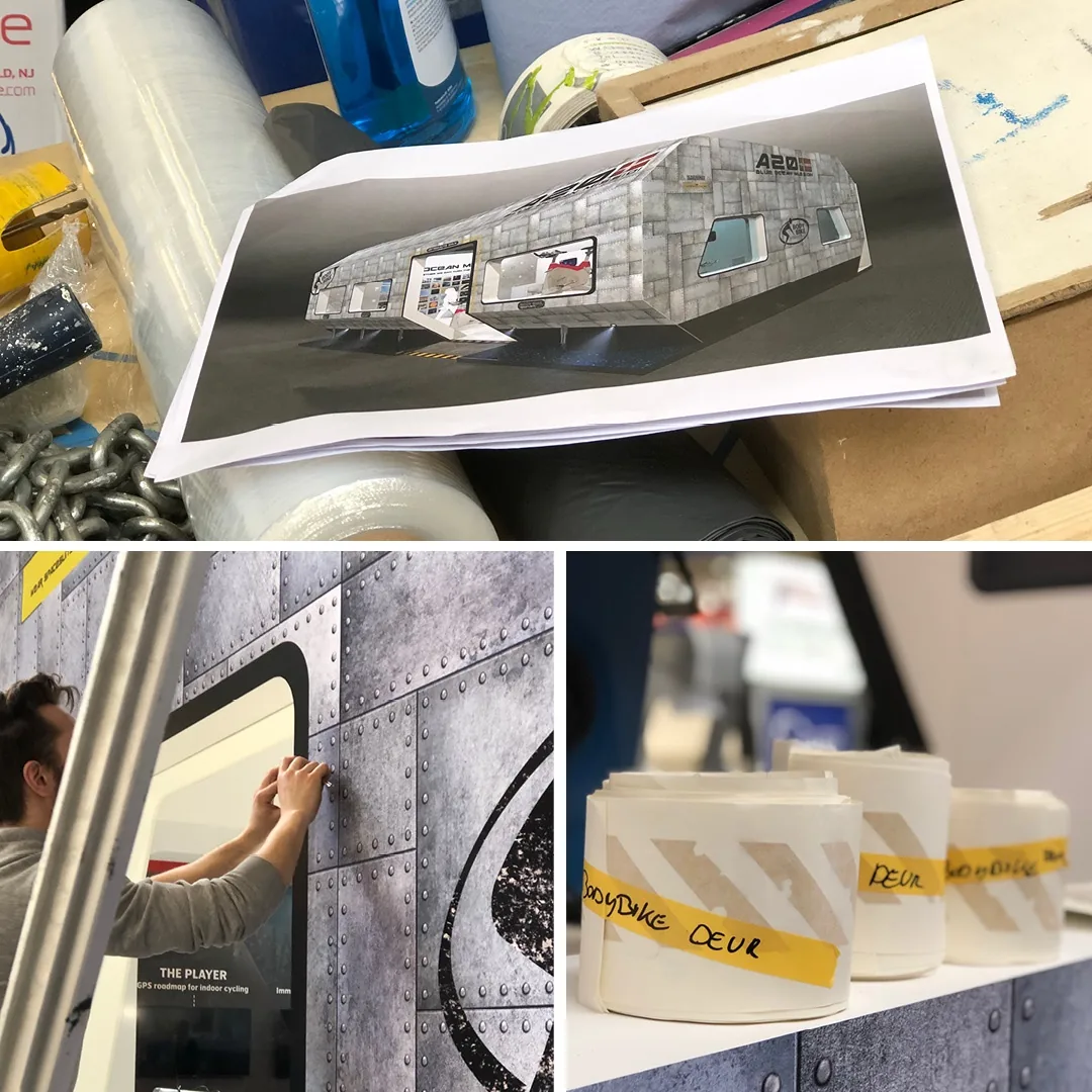 Opbouw van de stand: het ontwerp op papier naast de bestickering van de patrijspoorten.